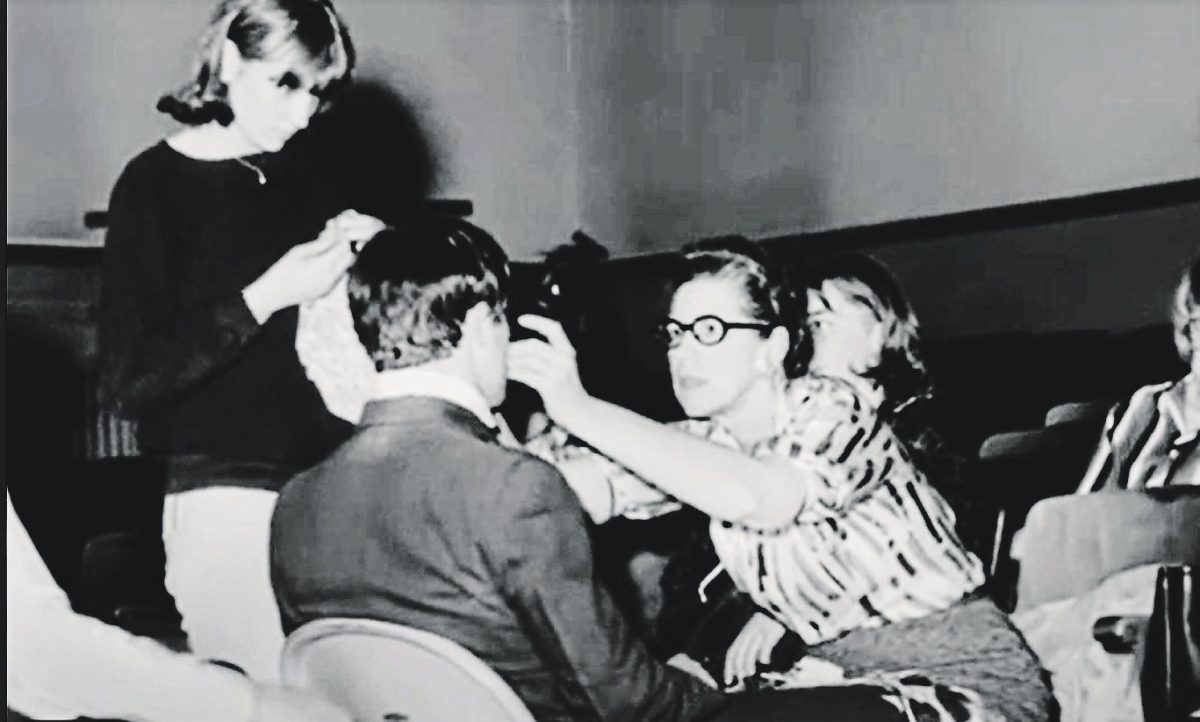 Gladys Rife helps a student adjust a costume during practice of a show. Gladys was the sponsor of the Troupe 50 years ago.