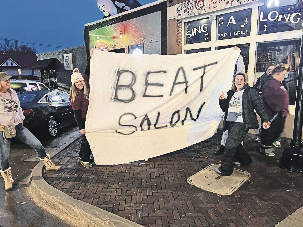 Mount Vernon fans line First Street ahead of the game with encouragement for the Mount Vernon football players Friday evening.