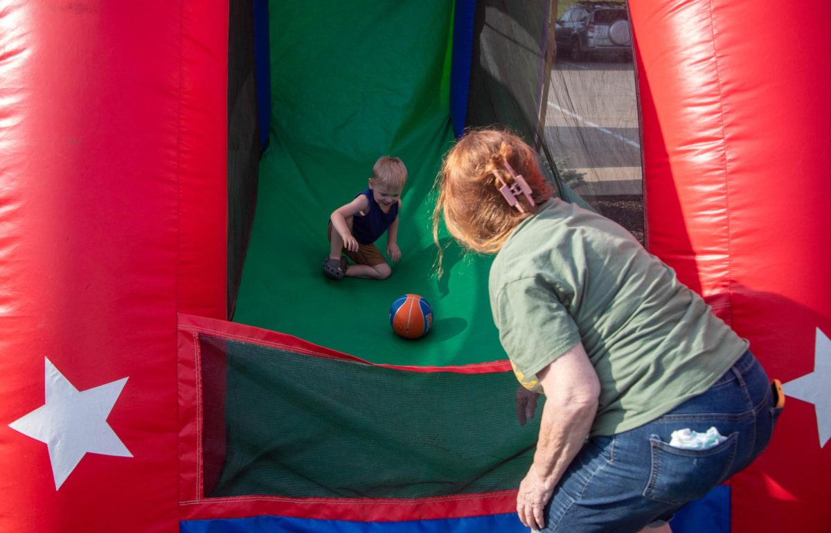 (right) Gail and (left) Jameson Logan play at the inflatable basketball hoop. There were many different activities for kids to do Friday night.