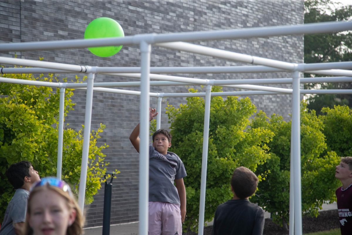 Novato Estrada hits the ball during nine-square. The game was one of the premier attractions on the grass as it went on during most of the festival on Friday night.