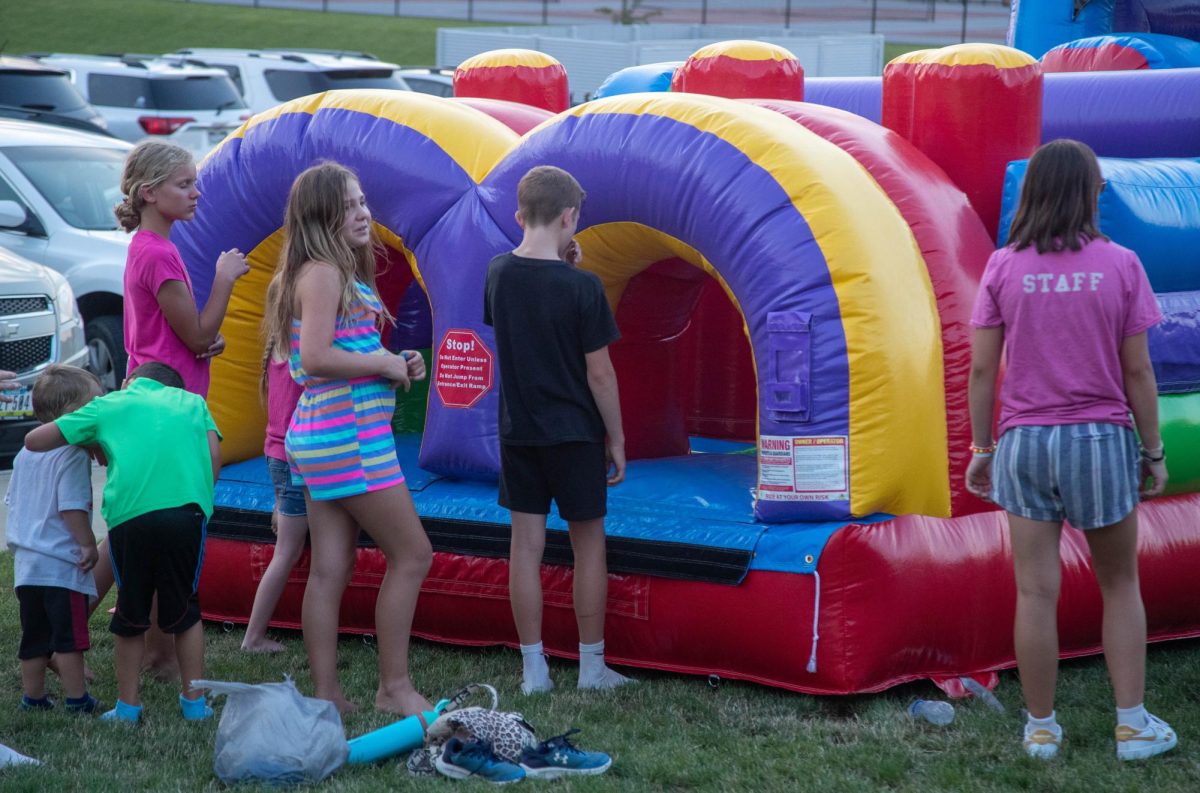 Kids await their turn to race through the obstacle course bouncy house. This was one of four inflatables for kids to play on.