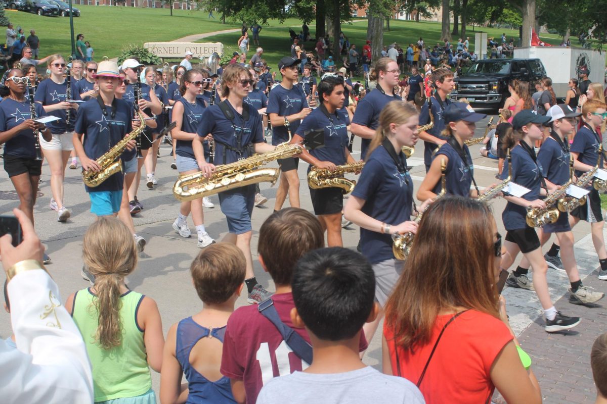 Members of the Marching Mustangs turn the corner onto Fifth Avenue during the parade Saturday, July 13. 