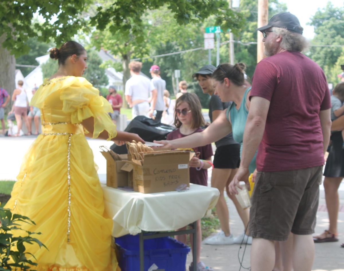 Cait O’Connor welcomes youth to the Memorial Park Fun Zone after the parade Saturday, July 13. 