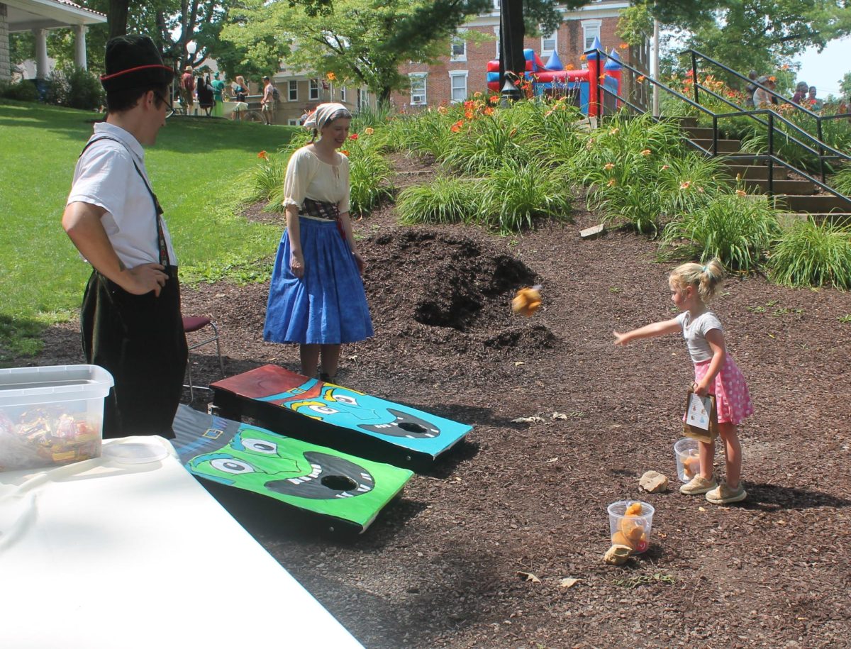 Isabella Bevins tosses some gingerbread at the witches mouths at the Memorial Park Fun Zone to save Hansel and Gretel. 