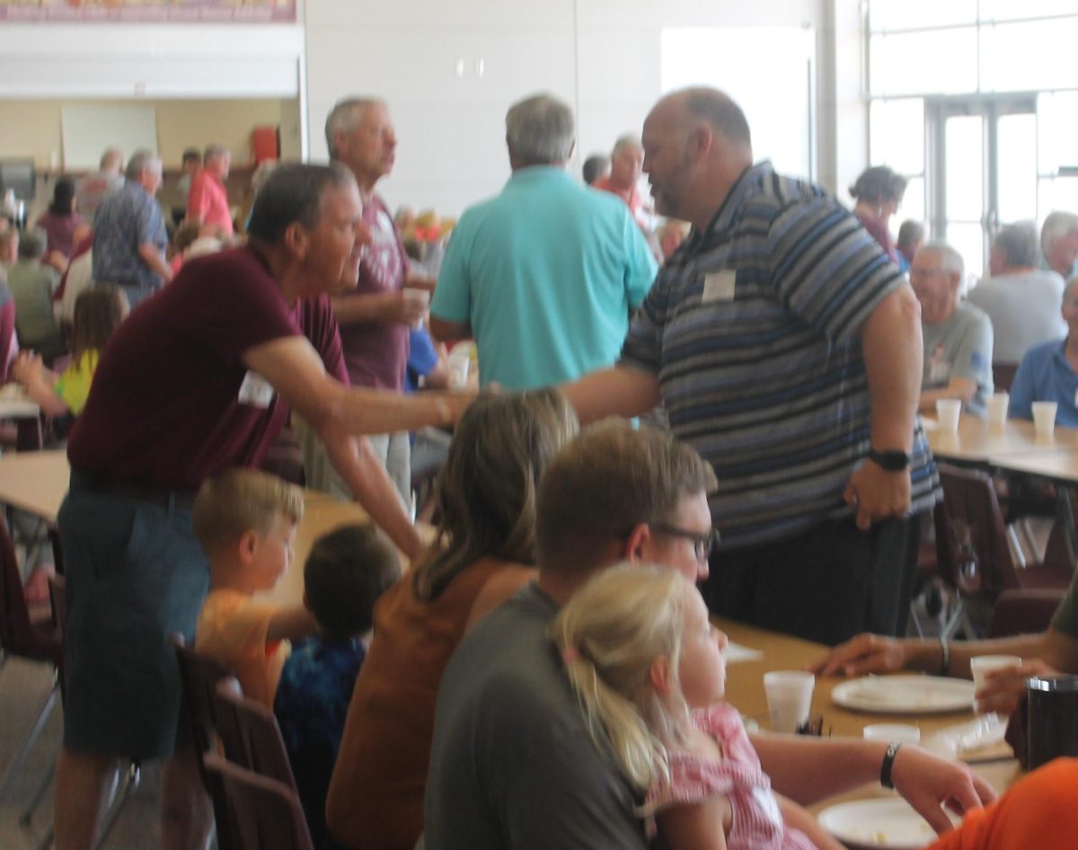 John Rife introduces himself to Matt Leeman at the alumni breakfast. 