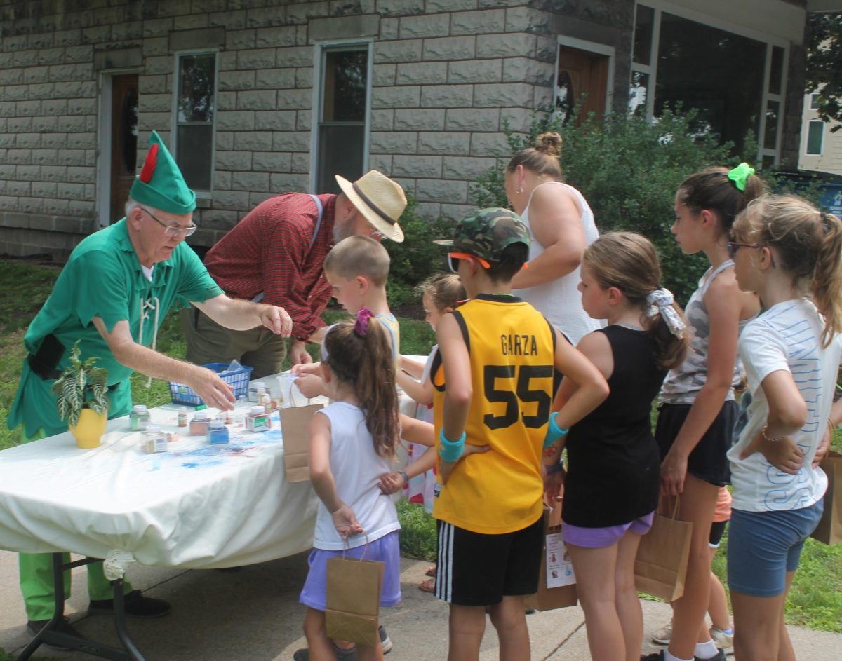 Peter Pan (Joe Jennison) imbibes some fairy dust on a craft at the Memorial Park Fun Zone Saturday, July 13.