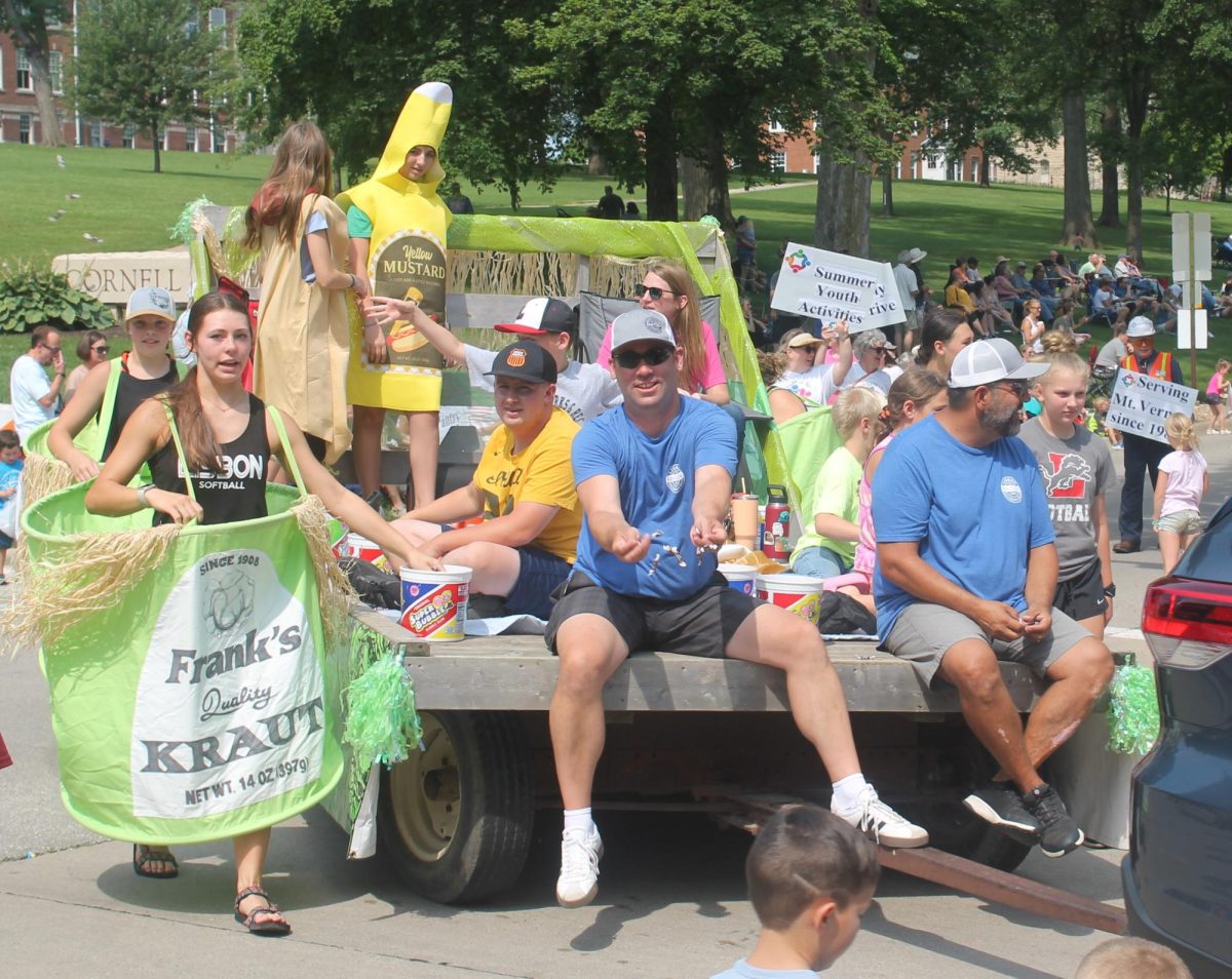 Members of the Lisbon Sauerkraut Days committee take part in the Heritage Days parade to remind people of the festival coming up in August. 