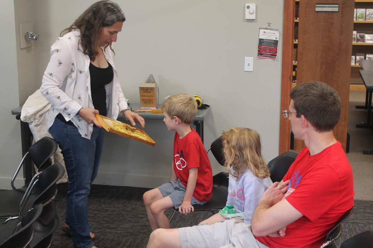 Stephanie Rice shows off some honeycomb hat bees had built up to members of the Brehm family Tuesday, July 23.