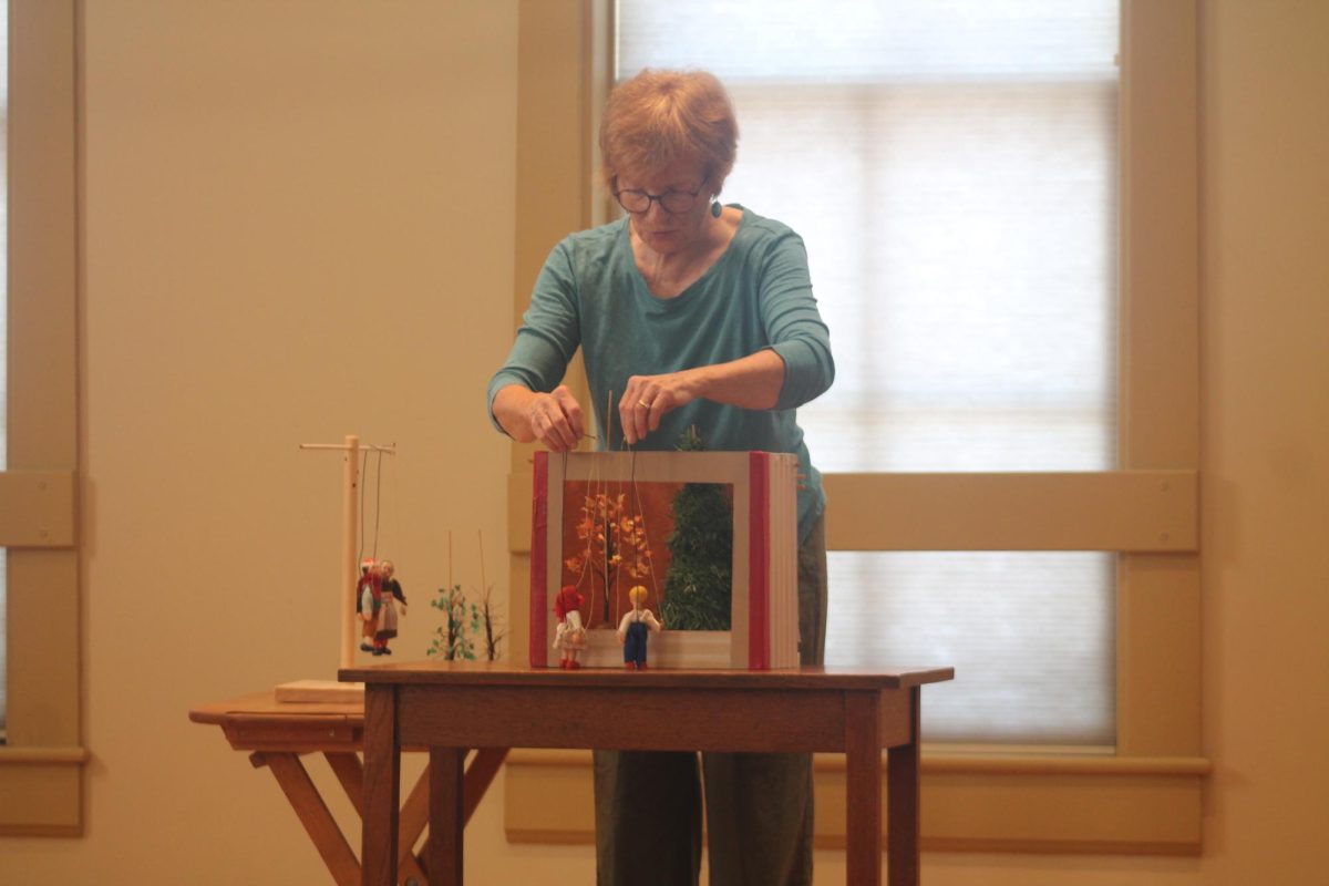 Amy White leads off the puppet show for “The Two Trees” at Lisbon story time Tuesday, July 30.