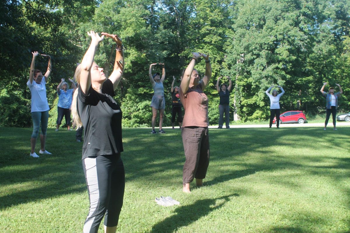 Participants walk through one of the action steps in Qigong Saturday at the Palisades-Kepler State Park.