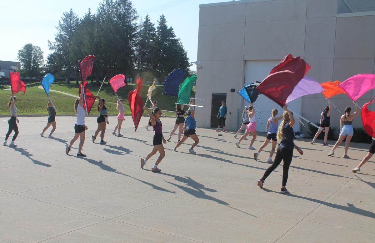 Members of the color guard practice different holds of their flags during band camp Wednesday, Aug. 7. 