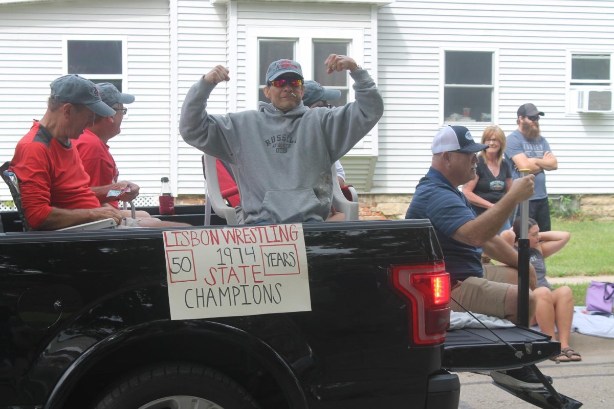 A Lisbon wrestler from the 1974 state wrestling team flexes during the Lora Light Memorial Parade Saturday, Aug. 17.