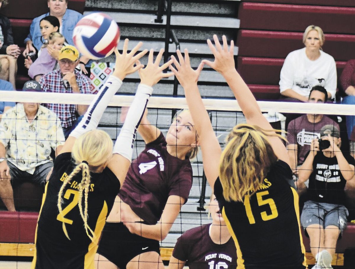 Mount Vernon’s Paige Schurbon (No. 4) nudges the ball over the net past some defenders in play last season.