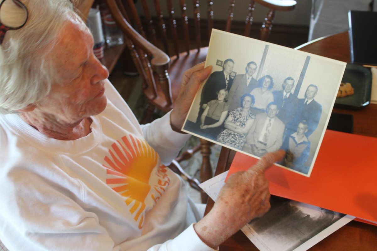 Bonnie Clark highlights members of the Ross and Laura Clark family in a photograph.