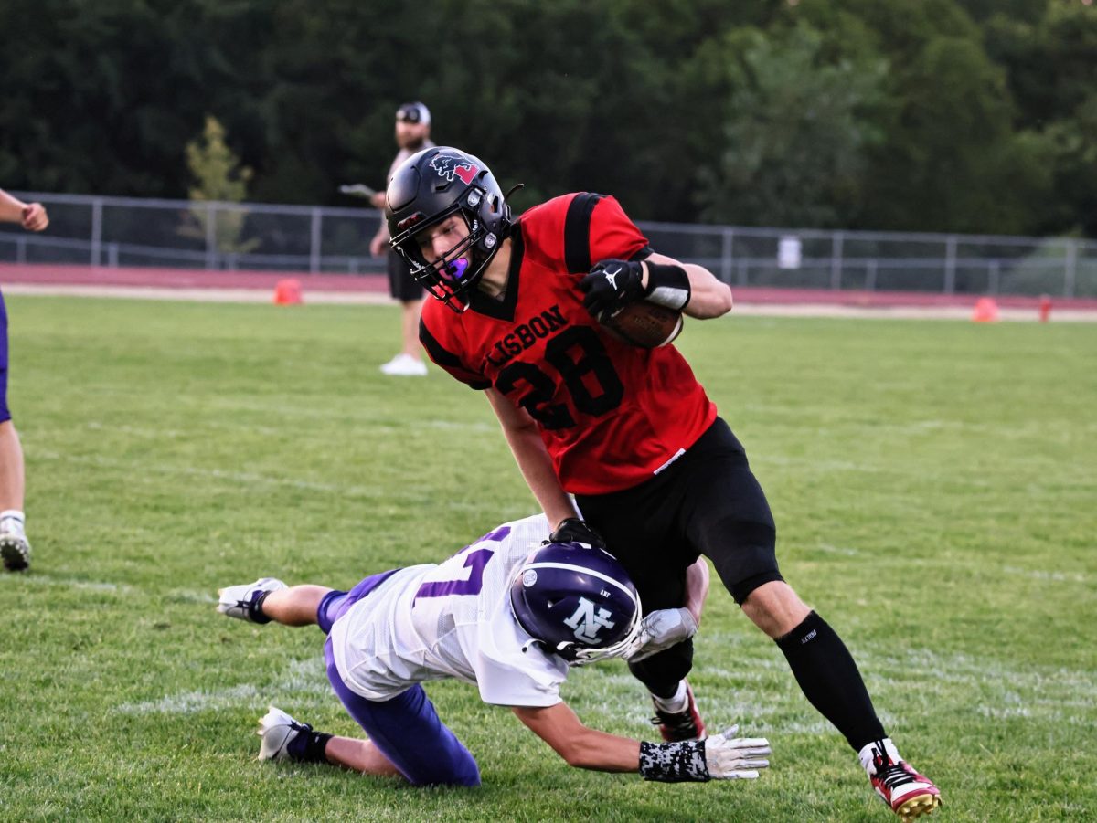 Lisbon senior Daylin Schaefer (No. 28) breaks away from a tackle from a North Cedar player during scrimmage Friday, Aug. 23. 