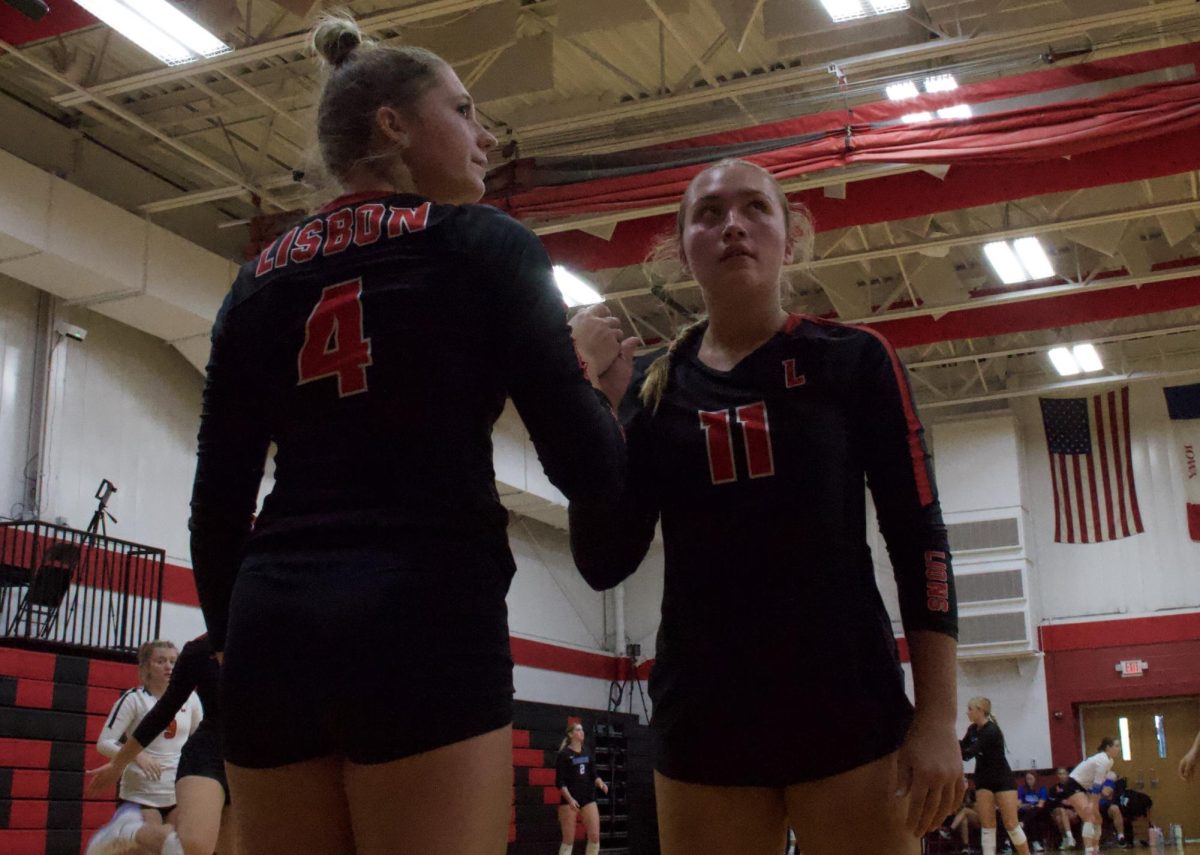 Lisbon volleyball players Kamryn Kahl and Kyla Kahl check in and out of the game, respectively, during a match against Davenport West on Sept. 1, 2024. The Lisbon Lions beat Davenport West, 2-0.