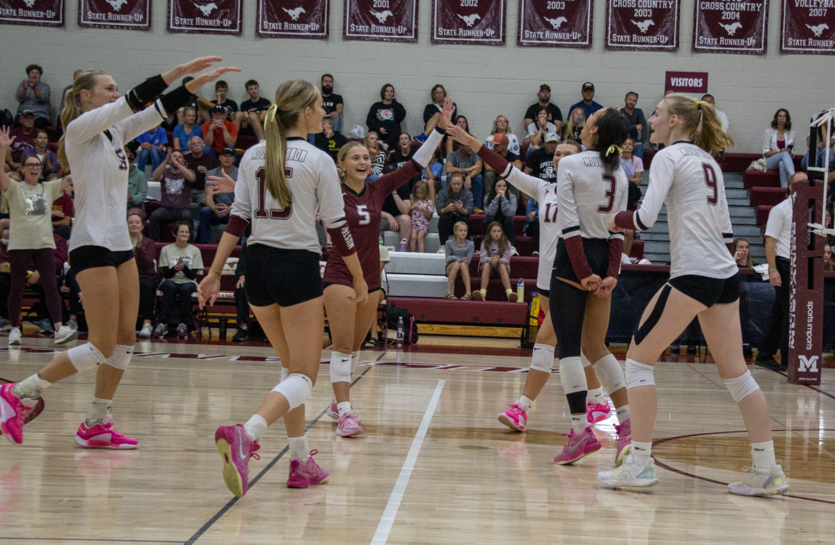 Coach Maggie Willems, Eryn Jackson (No. 5), Sophia Meester (No. 17), Sydney Maue
(No. 9), Cali Whitaker (No. 3), Sydney Huber (No. 15) and Chloe Meester (No. 16) celebrate the
victory on the court.