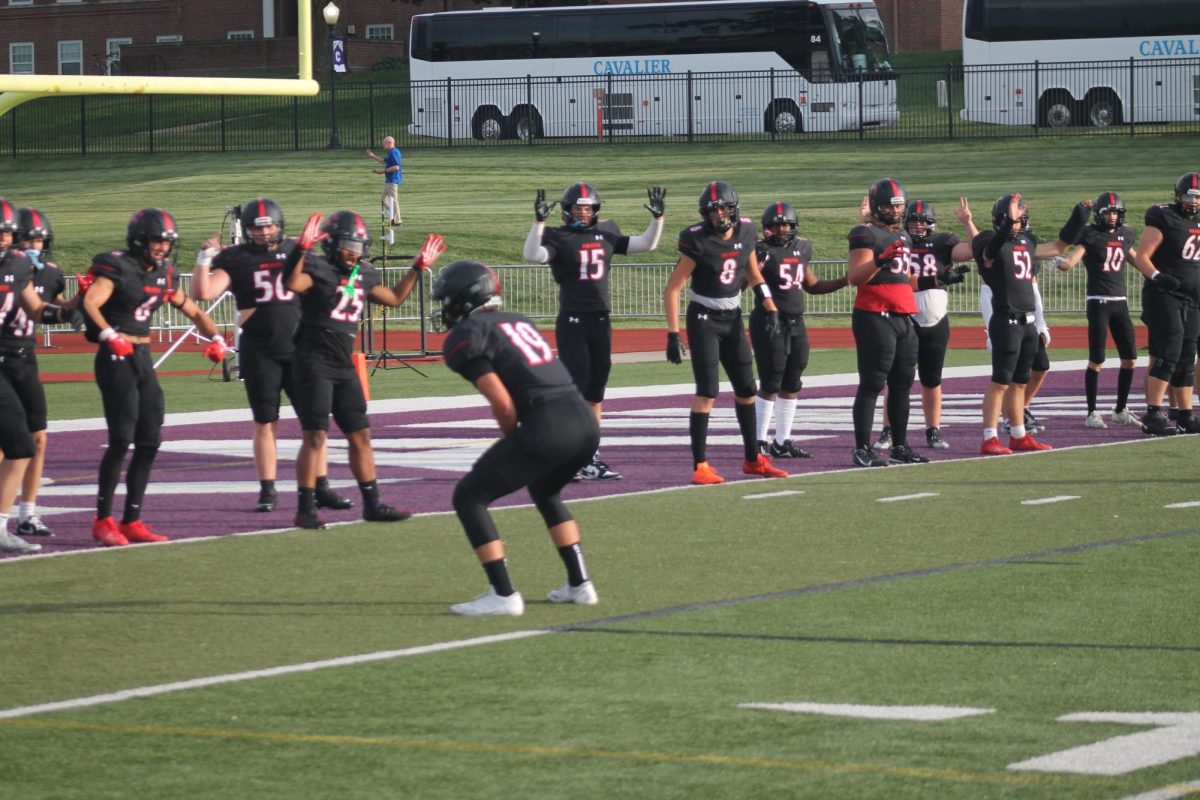 Members of the Pewaukee Pirates practice a running warmup Friday, Aug. 30. 