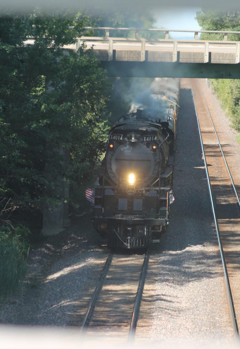 The steam engine Big Boy No. 4014 passes under the First Street highway bridge and towards the old Lincoln Highway Bridge Friday morning near Cornell College. The train was bound for Rochelle, Ill., with a whistlestop planned in Grand Mount at 11 a.m.