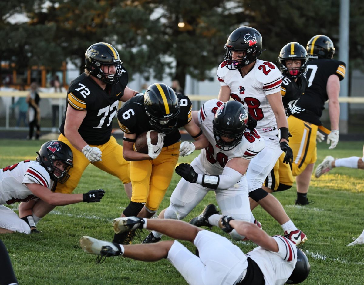 Lisbon players Jacob Walerius
(No. 60), Austin Kelsey (No. 15) and Daylin Schaefer (No. 28) work on tackling a Louisa-Muscatine player.