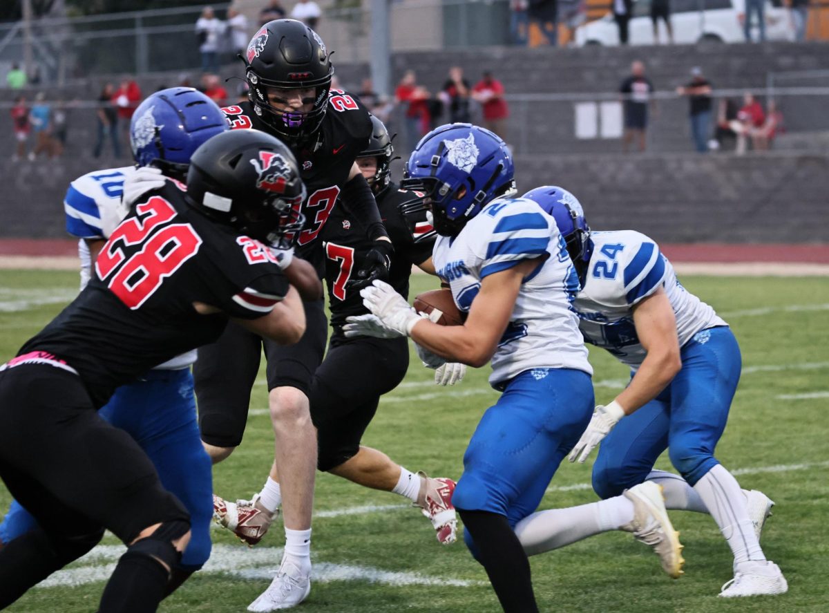 Lisbon players
Grayson Wollum (No. 23)
Daylin Schaefer (No. 28)
and Tiernan Boots (No. 7)
converge on a Columbus
player Friday, Sept. 13.