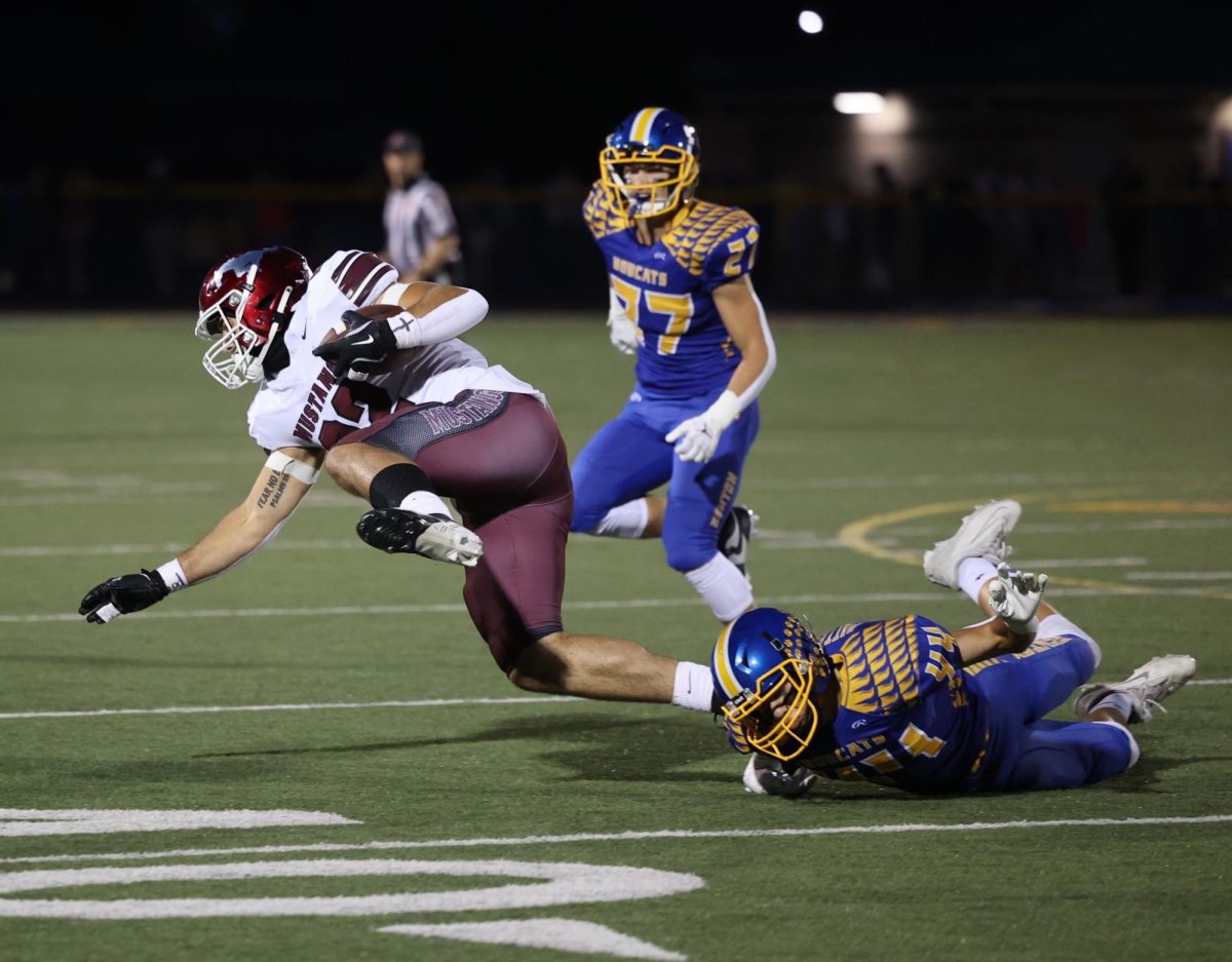 Mount Vernon’s Ethan Wood (No.
22) tries to get a few more yards out
of a carry following a Benton tackle
attempt.