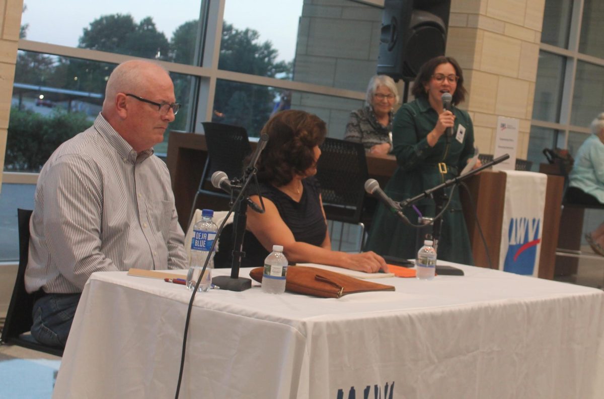 Candidates Kent McNally and Cindy Golding listen to a question from moderator Megan Goldberg during the legislative forum. 