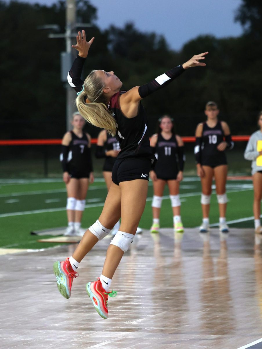 Sydney Maue spikes the ball down on Manchester players Tuesday, Sept. 17.