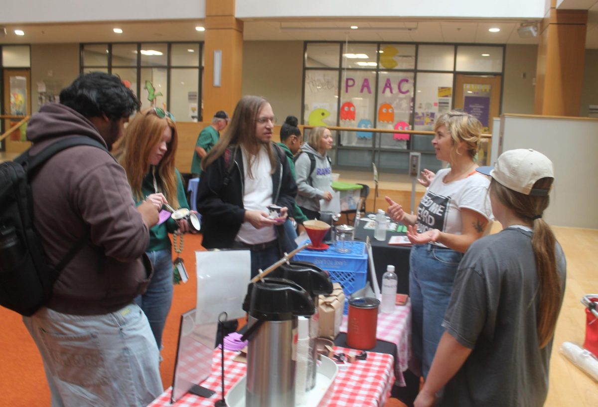 Little scratch Coffee co-owner Katrina Sogaard Anderson has a small quiz before offering free samples of the coffee at the Orange Carpet in Thomas Commons at the farmers market. 