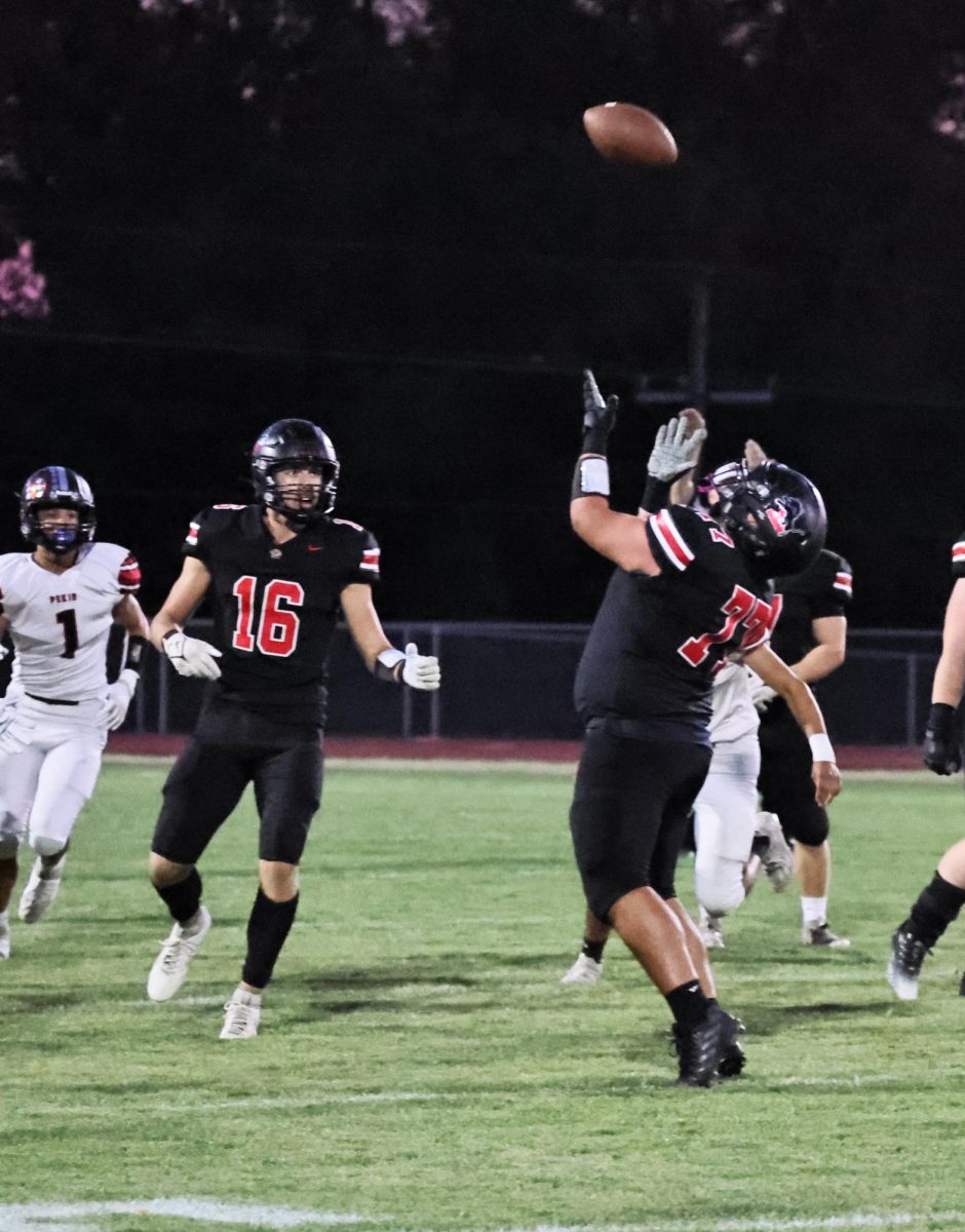 Lisbon’s Ethan Hoekstra (No. 77) tries to catch a live ball in play earlier in the season.