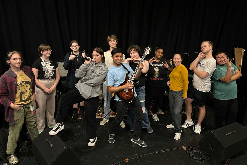 Members of the Pop/Contemporary Ensemble strike a fun pose at a rehearsal.