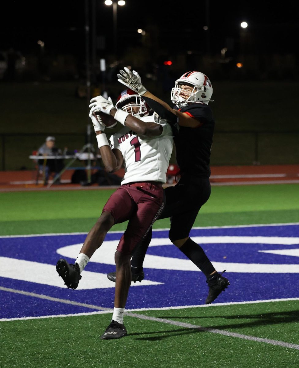 Mount Vernon’s Watson Krob (No. 1) pulls down a catch amidst defense at Davenport Assumption.