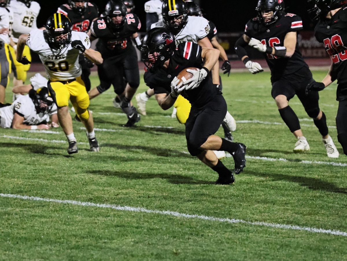 Lisbon’s Dakota Clark (No. 1) catches a punt for the Lions under the defense of Starmont.