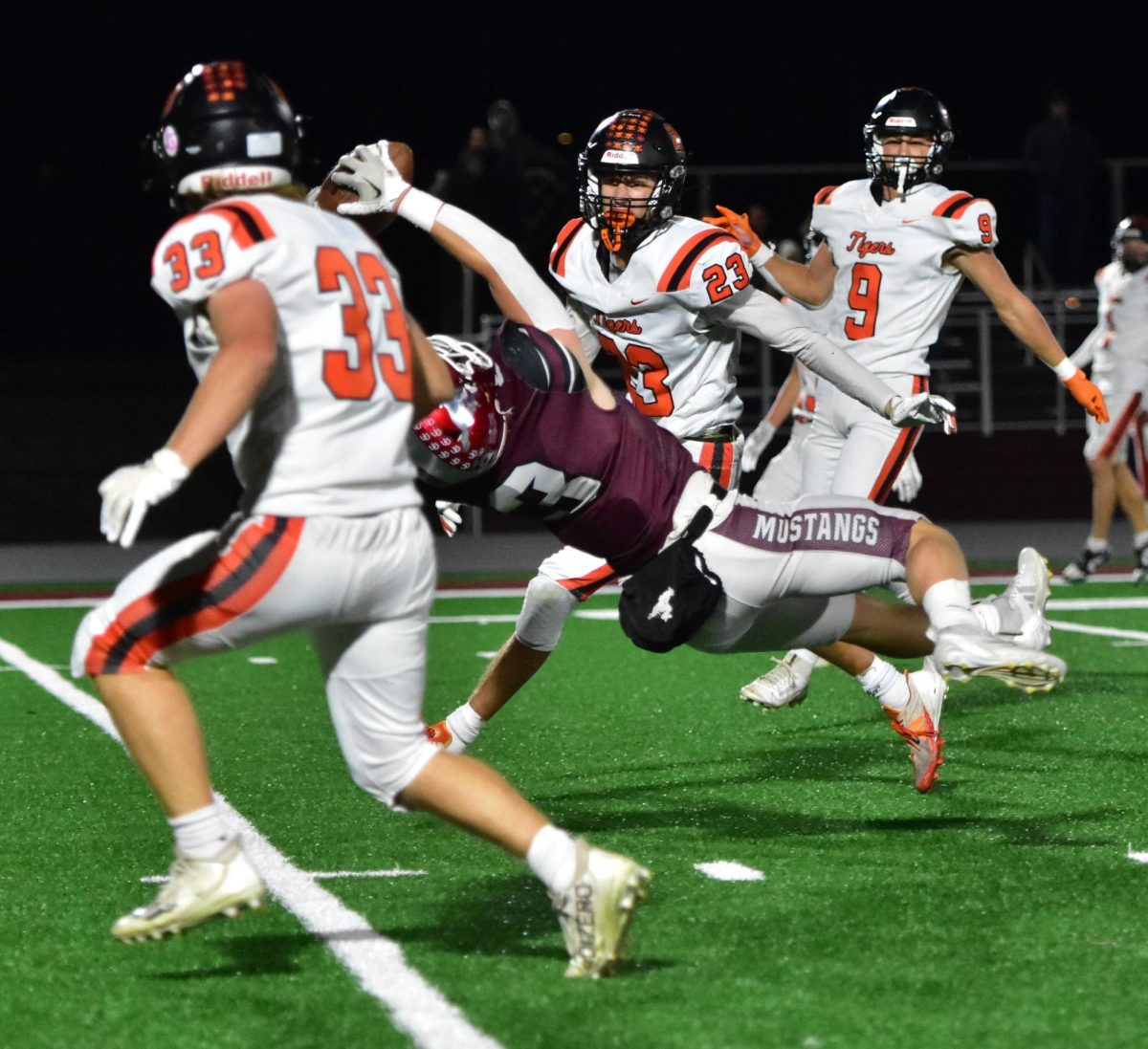 Michael Ryan (3) makes a reception, to the amazement of a trio of Carroll Tigers, in a Class 3A First Round (Round of 16) game this past Friday at home. The Mustangs (9-1) rolled over the Tigers 42-6 to advance to the Quarterfinal round with a game this Friday at Algona (9-1).