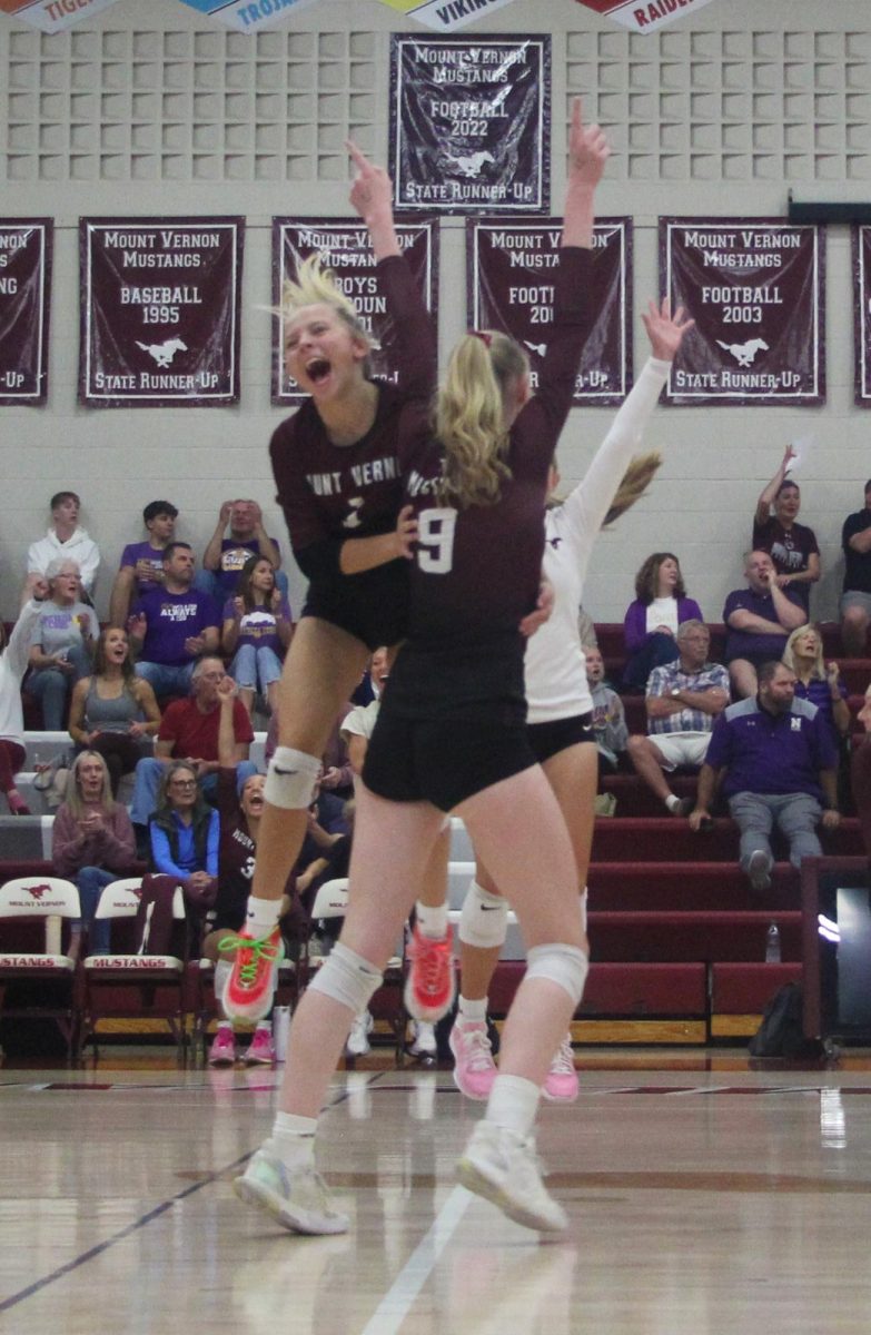 Mount Vernon’s Mavrik Schweer (No. 1) and Sydney Maue (No. 9) as well as other teammates celebrate a point at home last week. 