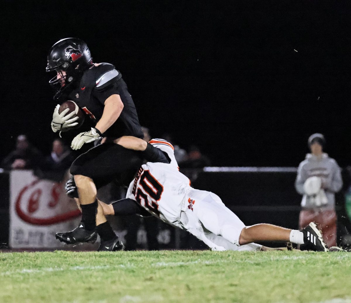 Lisbon’s Tiernan Boots (No. 7) fights against a Madrid tackler to gain a few more yards in a drive Friday, Nov. 8.