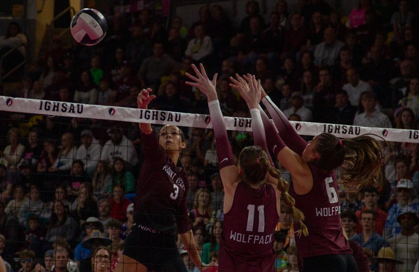 Mount Vernon’s Cali Whitaker hits a ball past two Western Christian blockers for a kill.