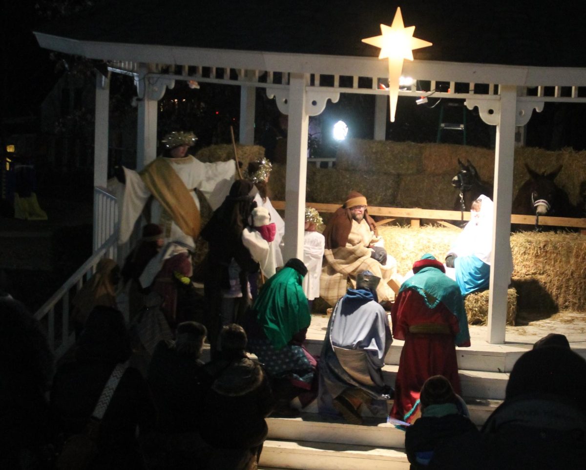 Nina Scott works on finishing a Christmas tree decoration in the Iowa Physical Therapy parking lot. Above: The Living Nativity Scene comes to a 
close at the 6 p.m. showing.