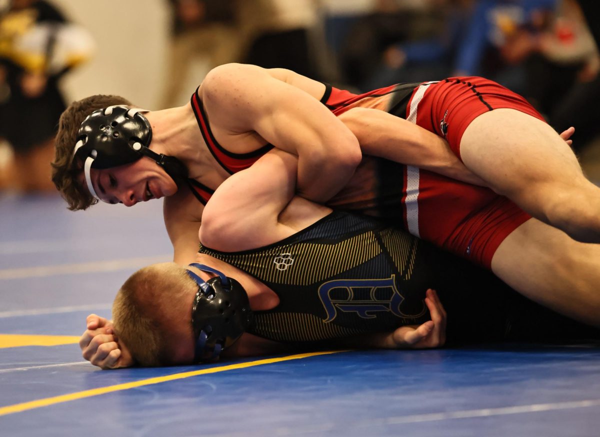 Lisbon junior Jackson Knapp works on pinning a wrestler from Durant.