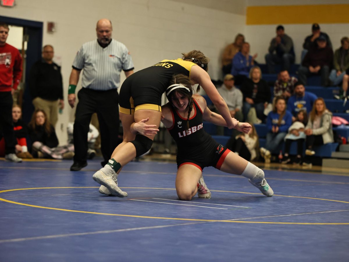 Lisbon’s Addie Clark grapples with a wrestler from Lone Tree.