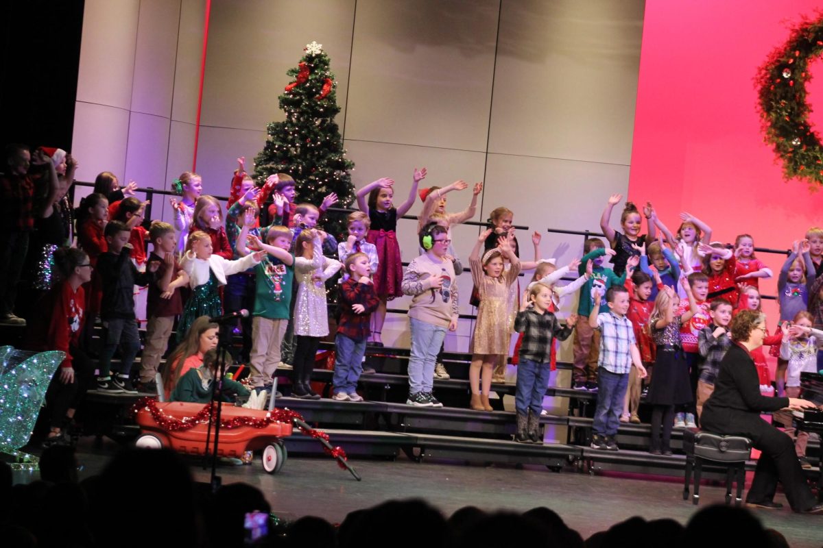 Washington Elementary first graders sing about “Seven Feet of Snow” at the concert Dec. 9. Above: Lisbon elementary third graders take the audience on a “Reindeer Parade.”