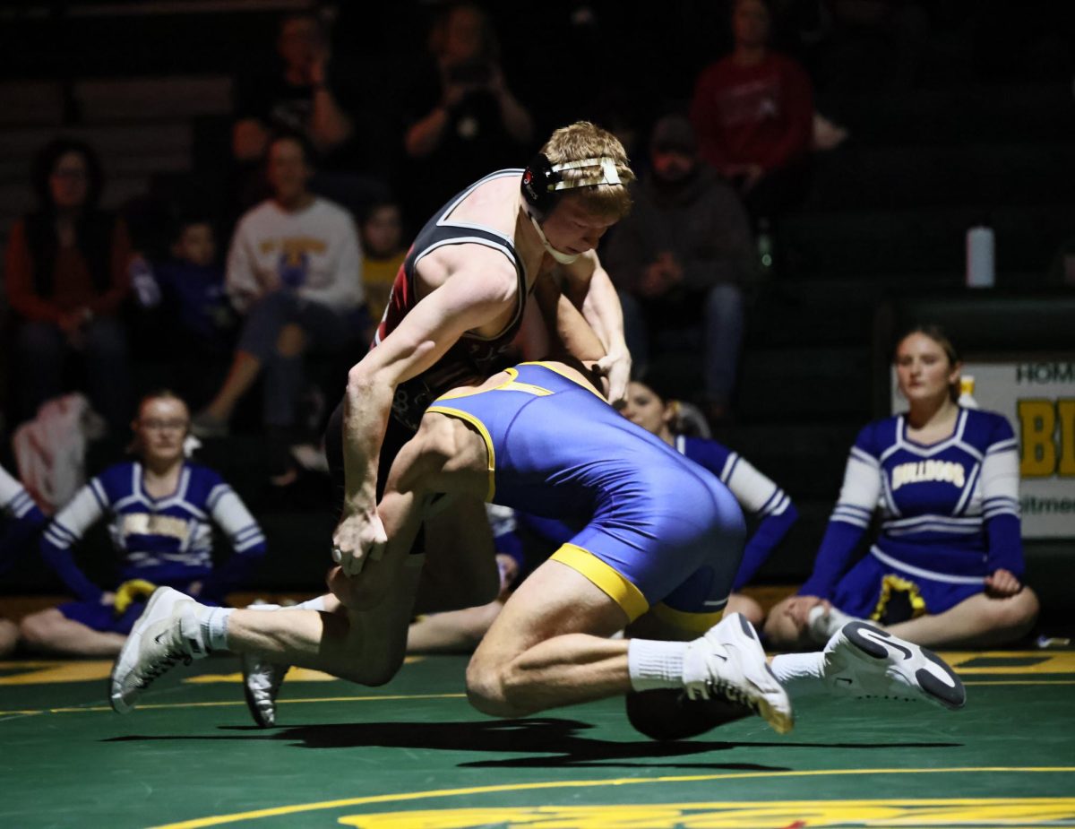 Lisbon senior Gage Holub grapples with an opponent on the mat at Dyersville-Beckman.