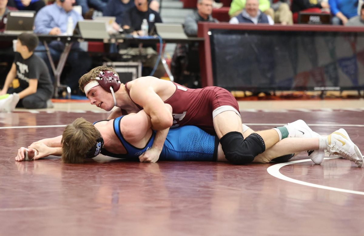 MV’s Will Goodlove grapples with a Clear Creek-Amana wrestler at Mount Vernon Thursday, Dec. 12. Below left: MV’s Watson Krob takes an opponent down to the mat.