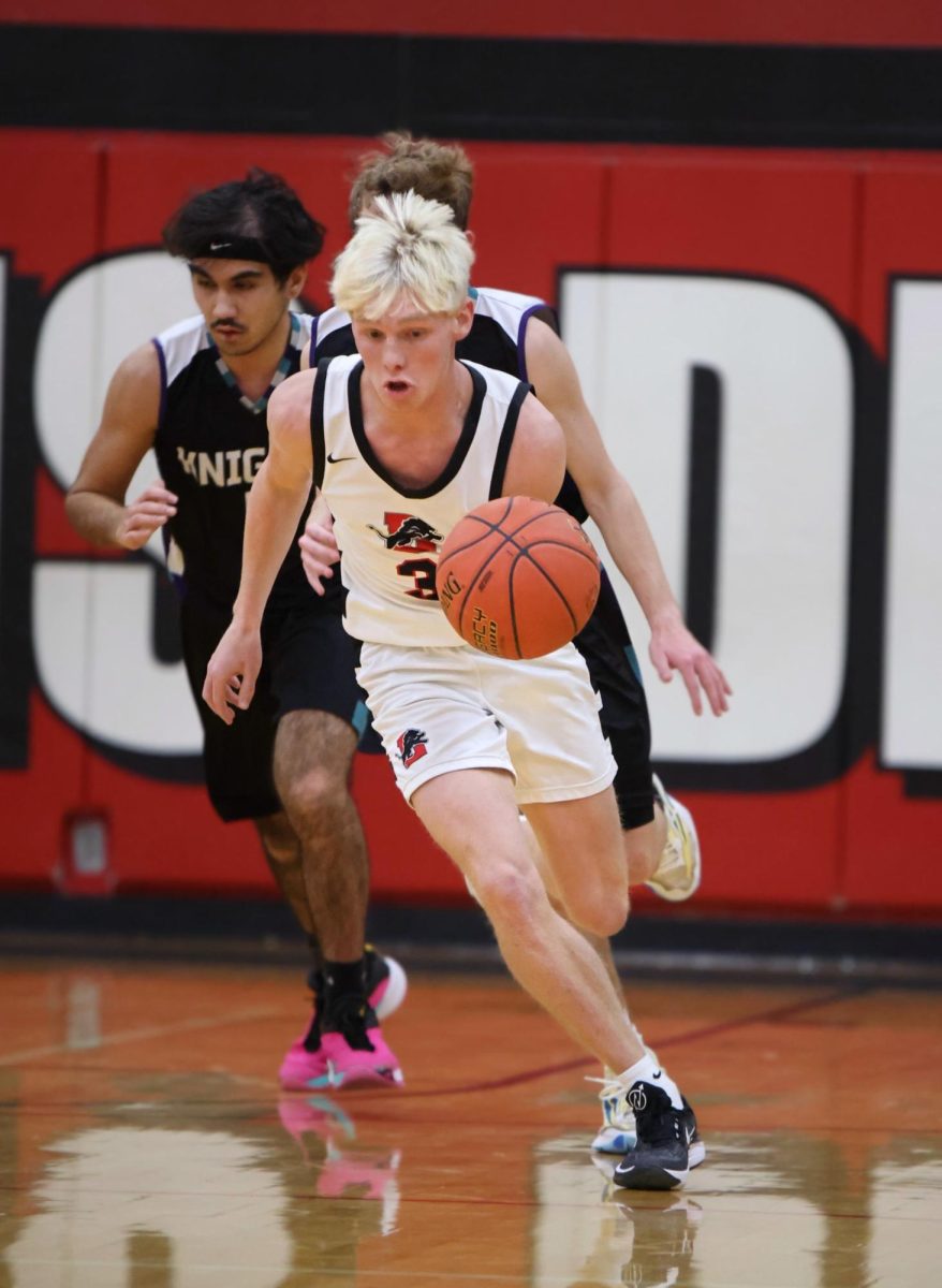 Lisbbb1 - Lisbon’s Dakota Clark (No. 3) dribbles the ball down the court against North Cedar. (contributed photo)