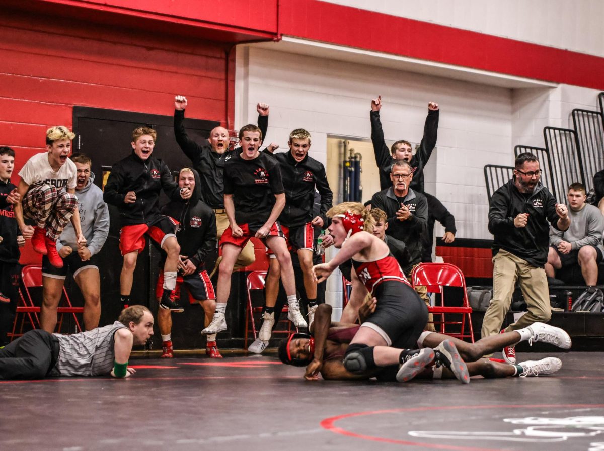  Caleb Brown of Lisbon gets the pin against Watson Krob of Mount Vernon as Lisbon’s bench erupts to the needed points for a win against the cross-town rivals. (contributed photo)