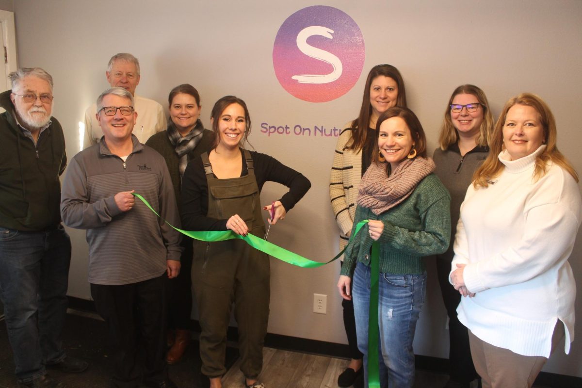 At the ribbon cutting for new owner of Spot On Nutrition were: John Bardsley (City of Lisbon), Tom Wieseler (Mount Vernon mayor), Jake Krob (Mount Vernon Bank and Trust), Courtney Frye-Speed (Bridge Community Bank), Ali Worrell (new owner Spot On Nutrition), Michelle Zaruba (Hills Bank and Trust), Jessie Thurn (Mount Vernon Lisbon Community Development Group director), Ashley Dunford (Mount Vernon Bank and Trust) and Brenda Langenberg (Hills Bank and Trust).