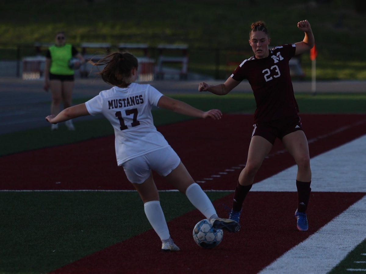 Mount Vernon’s Courtney Franck (No. 23) tries to defend the ball advancing from a defender on the soccer pitch.