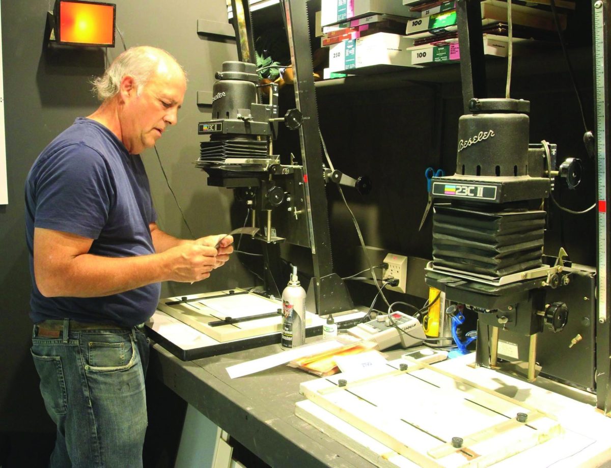 Bob Campagna working in his photography darkroom.