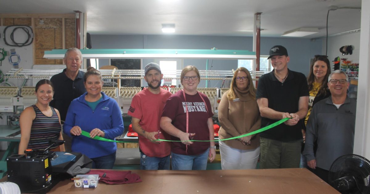 At the ribbon cutting for Midwest Designs Friday, Sept. 26, were (from left) Jessie Thurn (Mount Vernon Lisbon CDG), Tom Wieseler (mayor of Mount Vernon), Courtney Frye Speed (Bridge Community Bank), Kaleb and Paige Eby (owners of Midwest Designs), Brenda Langenberg (Hills Bank and Trust), Casey O’Connor (Town Office Suites), Michelle Zaruba (Hills Bank and Trust) and Jake Krob (Mount Vernon Bank and Trust).