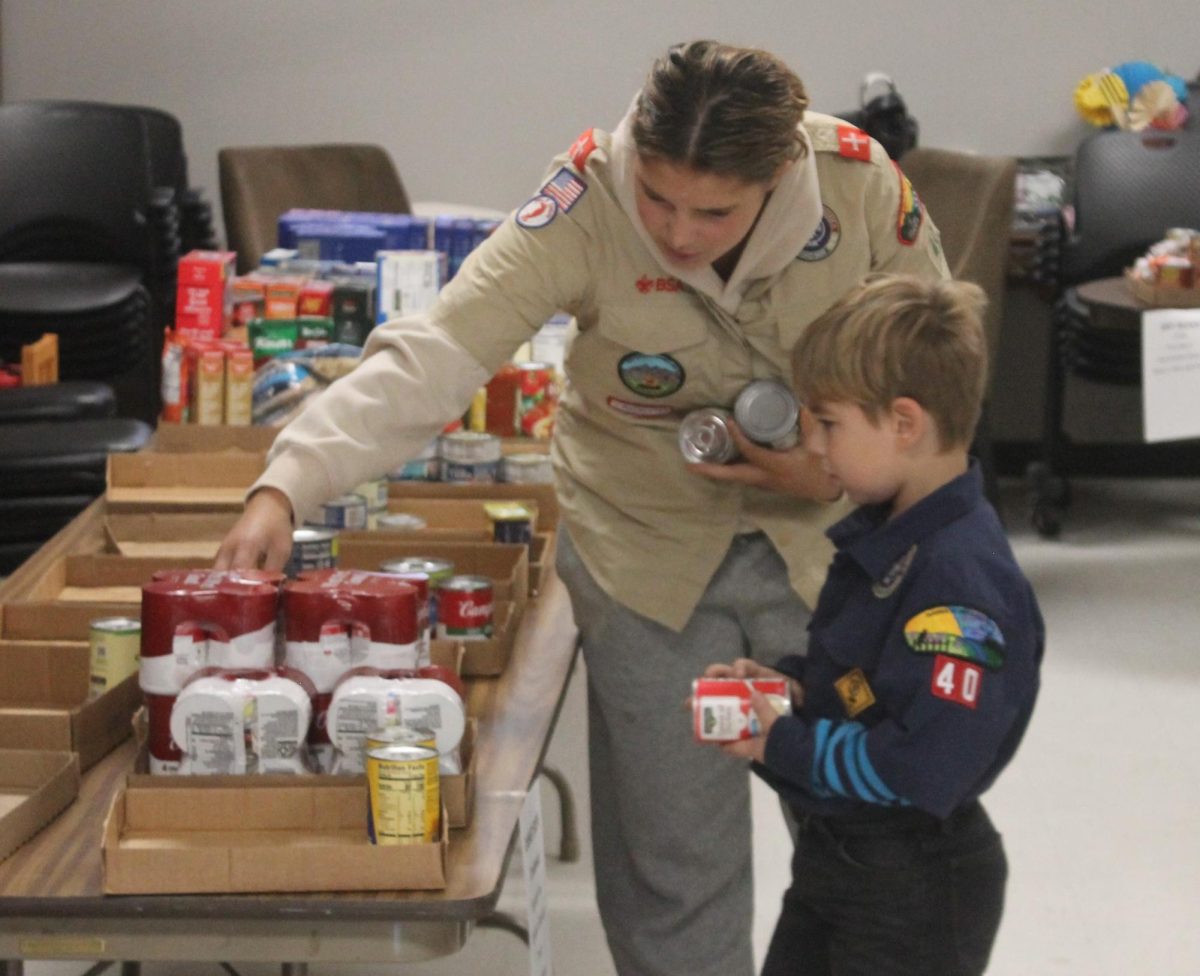 Caden and Caitlyn work at sorting some of the donations at Southeast Linn Community Center from the Scouting for Food Drive.